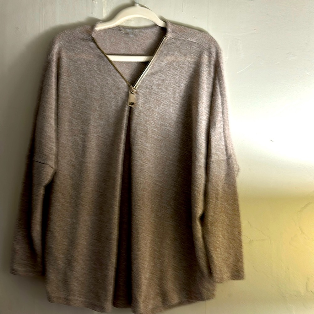 Women’s gently used blouse with zip front design